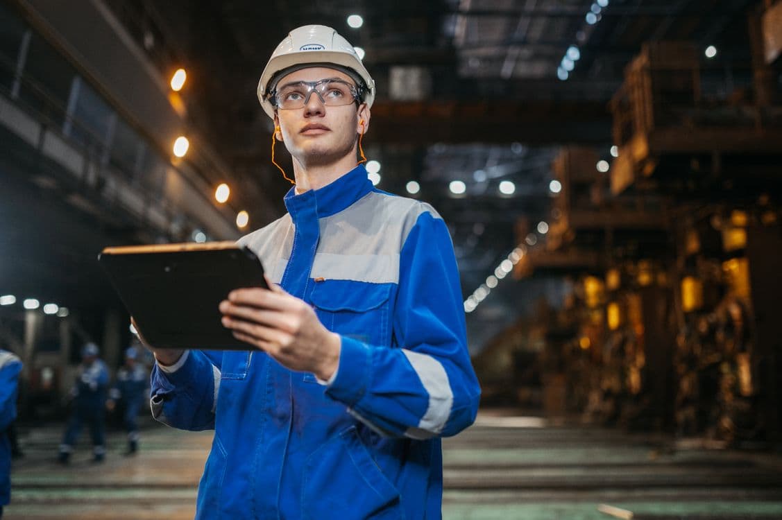 Engineer reviewing a digital system on an industrial tablet